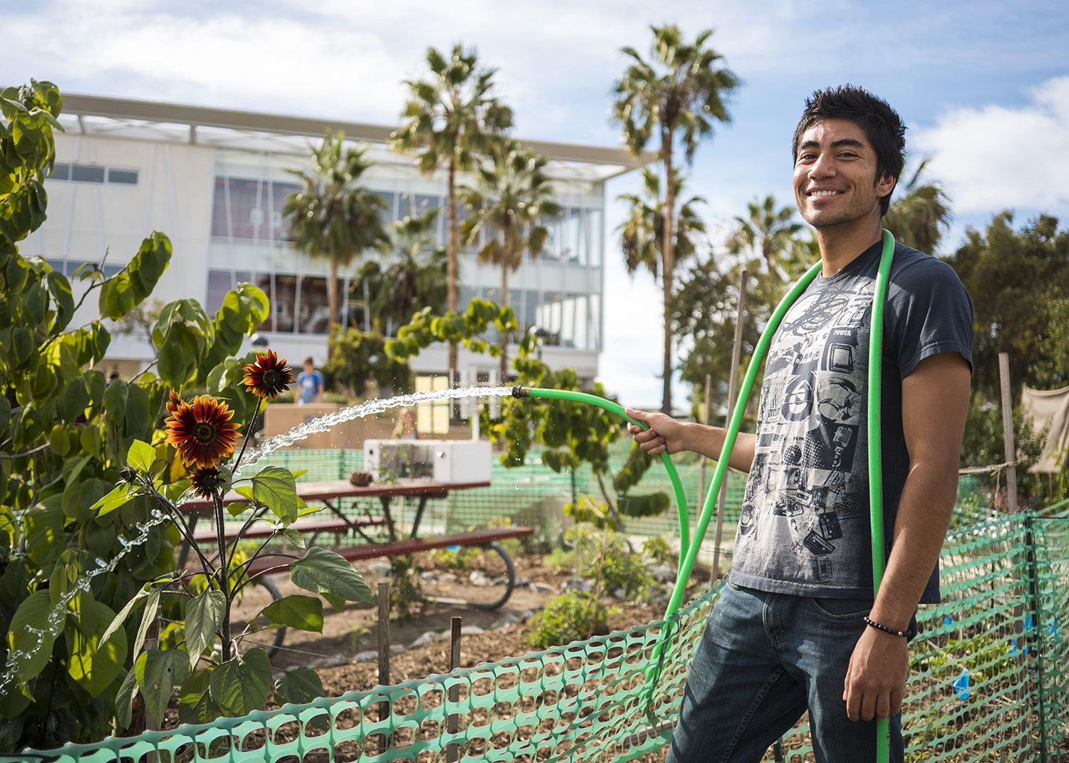 Sustainability club student watering the garden